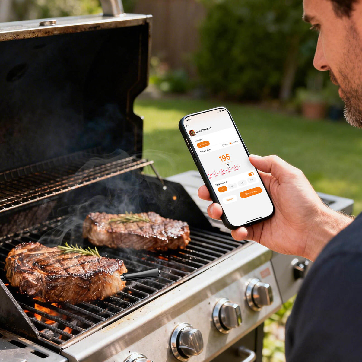 A Man Monitoring Steak Temp on Phone with INT-12-BW